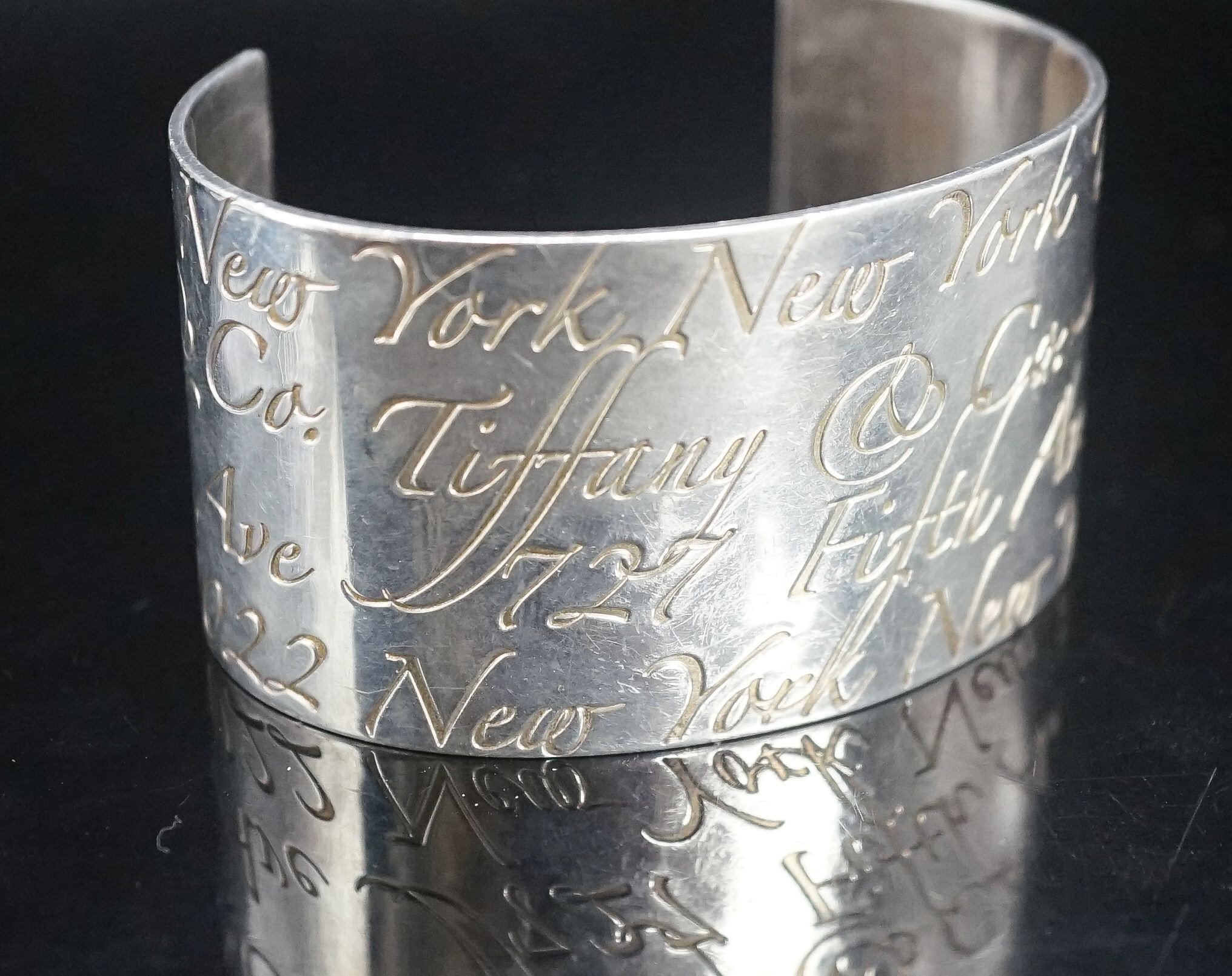 A Tiffany & Co 925 open bangle with engraved script, interior diameter approx. 69mm.